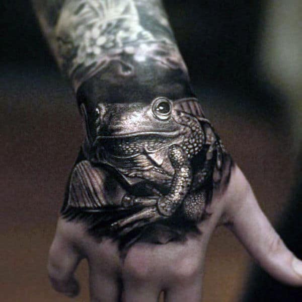 Black And White Ink Shaded Realistic 3d Male Hand Frog Tattoos