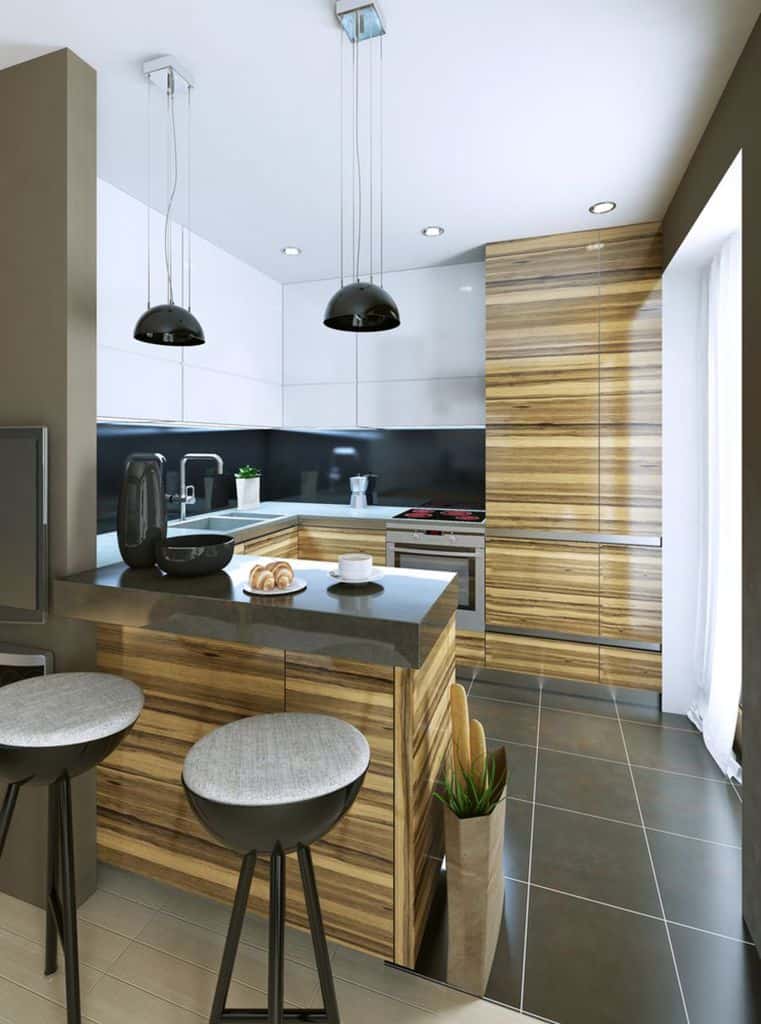Contemporary kitchen with wood-grain cabinets, black countertops, bar stools, and pendant lights.