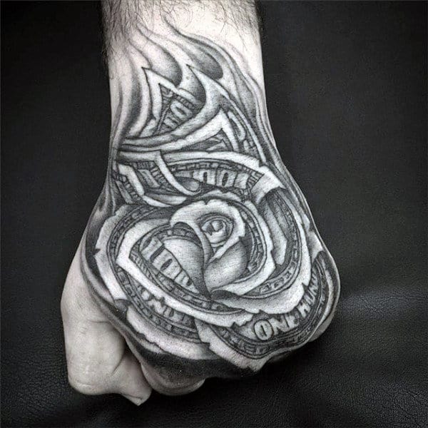 Tattoo of a rose made from dollar bills on a hand