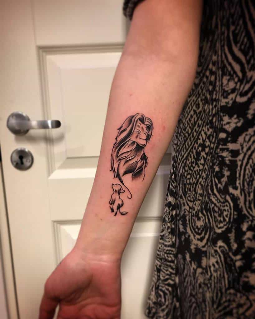 Black and gray tattoo of Simba in two stages, featuring his cub form at the bottom and his mature lion form above, symbolizing growth