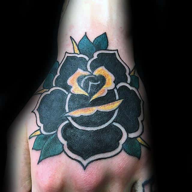 Tattoo of a black and yellow rose with green leaves on a hand