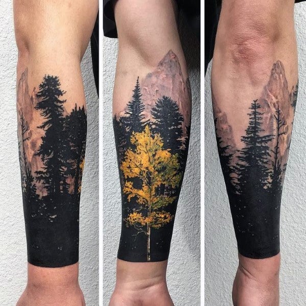 Realistic forest tattoo sleeve featuring dark pine trees, a vibrant yellow aspen, and towering mountains in the background, blending nature and artistry.
