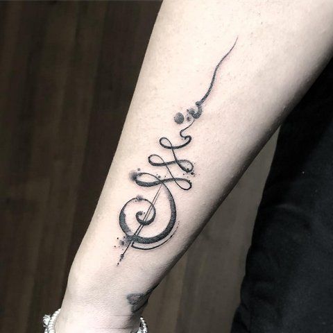 Bold Unalome tattoo with artistic shading on the forearm, symbolizing the journey to enlightenment, personal growth, and inner balance.