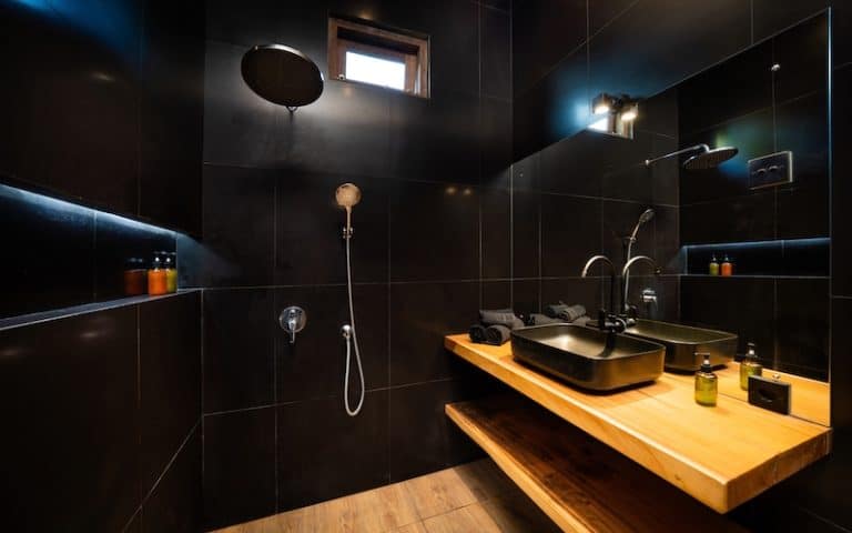 black bathroom with wood vanity