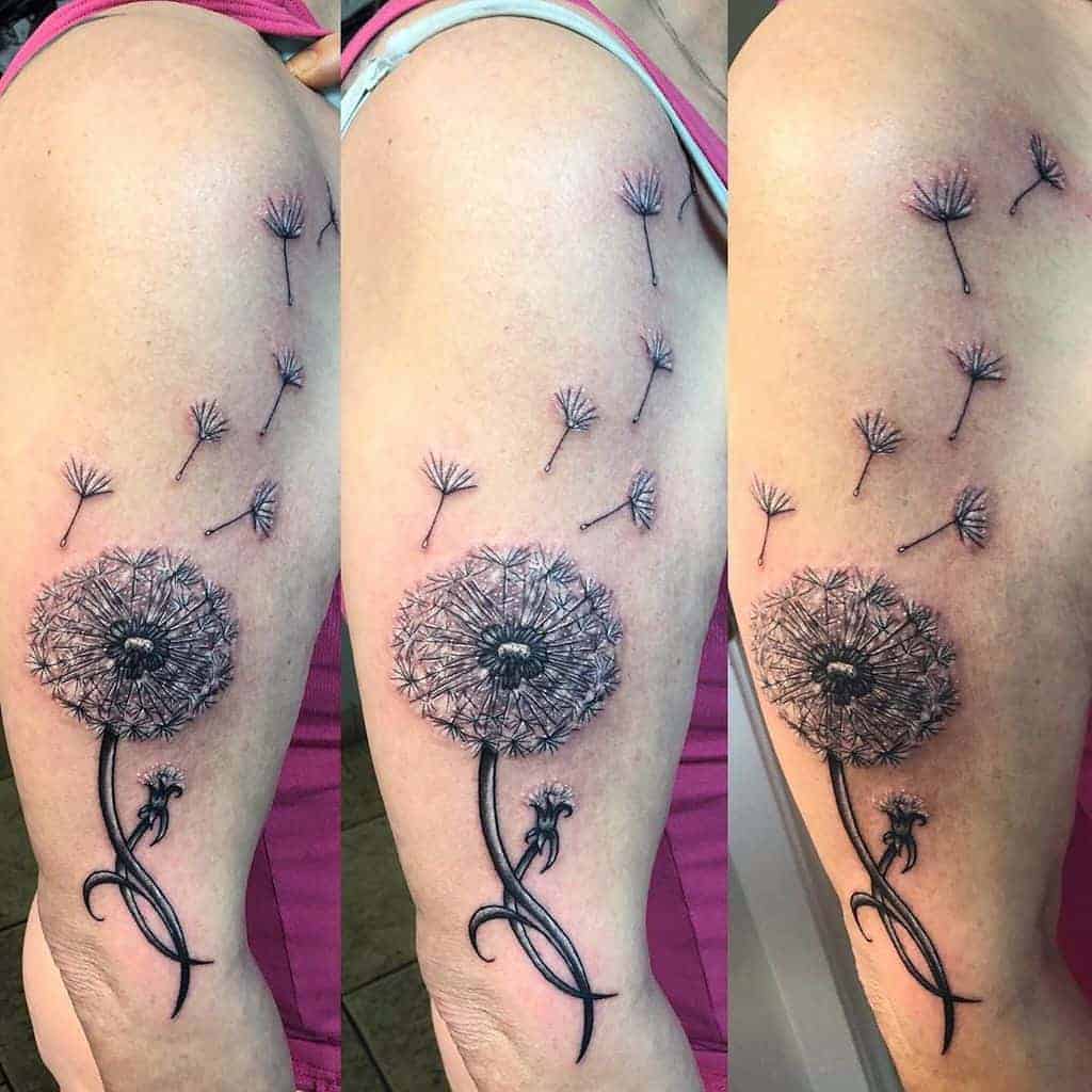 Tattoo of a dandelion on an arm, with seeds blowing away