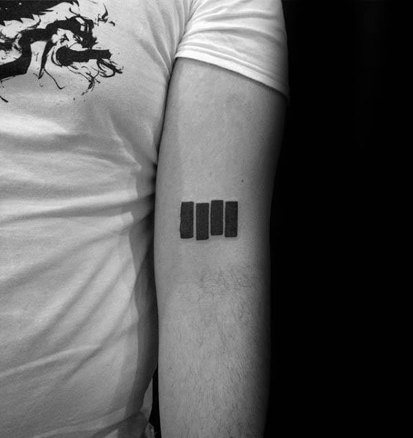 Minimalist Black Flag bars tattooed on the upper arm, cleanly aligned to represent raw punk identity and DIY ethos.