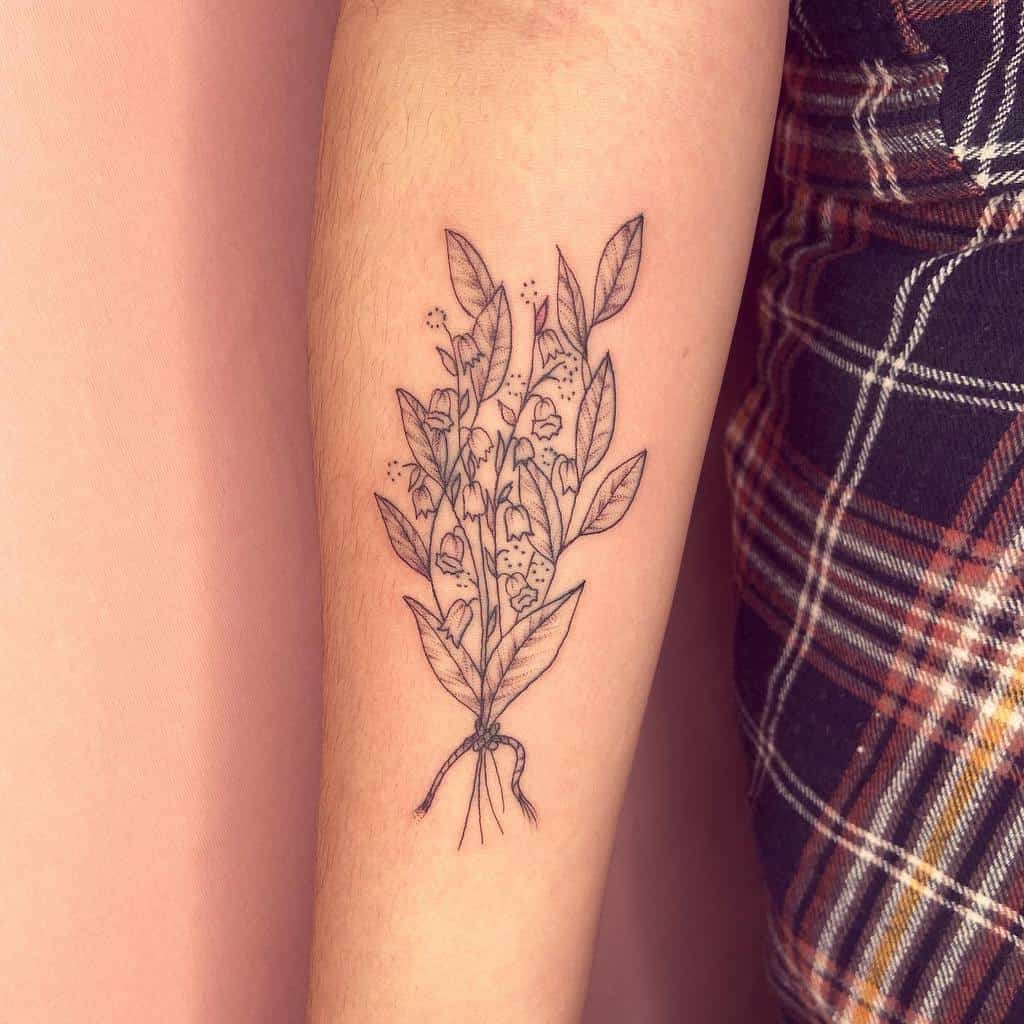 Fine-line Lily of the Valley bouquet tattoo, featuring delicate flowers, leaves, and a tied rope on the root for a natural, elegant look