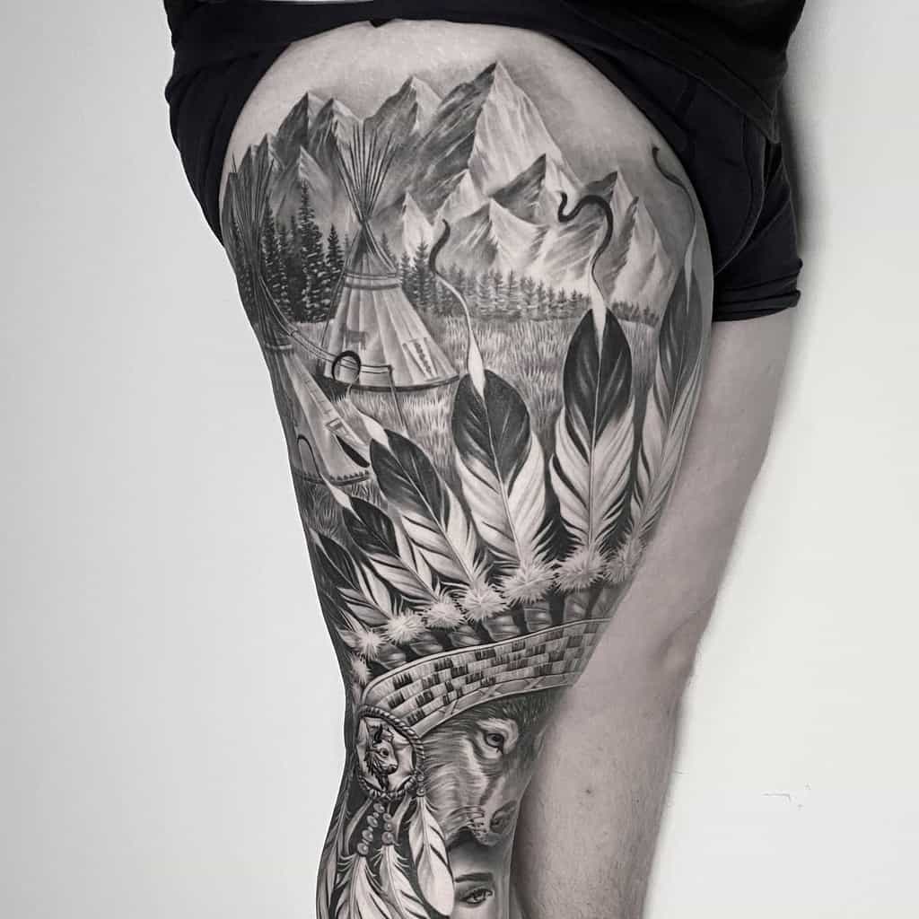 Black and gray leg sleeve tattoo featuring mountains, a teepee, and feathers, fox and a woman