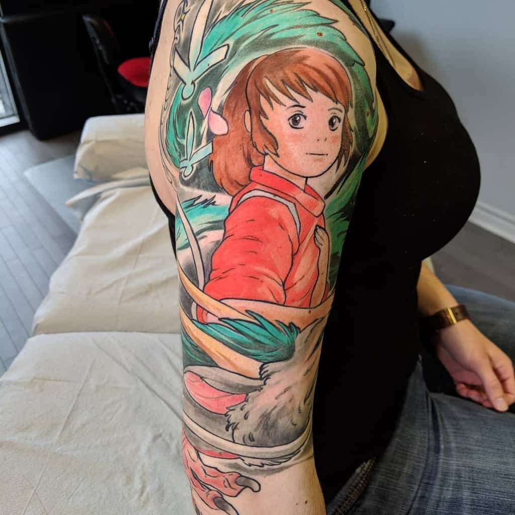 Vibrant tattoo of Chihiro from Spirited Away, featuring flowing elements, Haku in dragon form, and soft watercolor shading