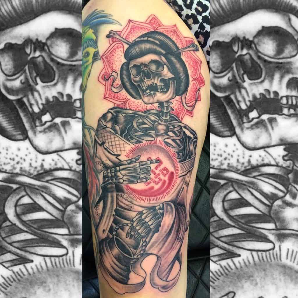 Skeleton Geisha tattoo with a red parasol and glowing orb, blending traditional Japanese elements with a dark, surreal aesthetic.