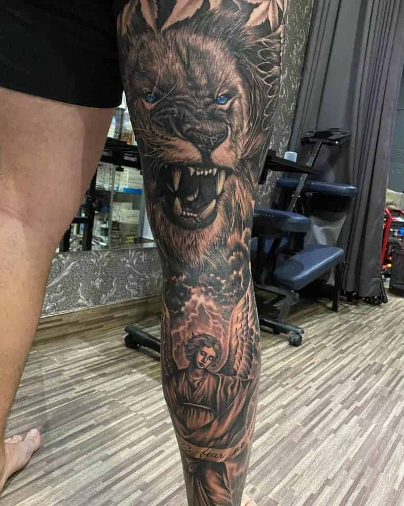 Tattoo of a roaring lion and angel on a person's leg