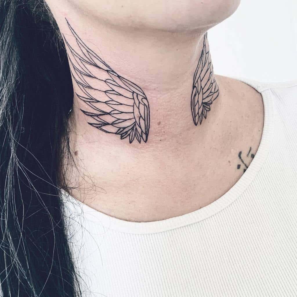 A delicate black ink angel wings tattoo symmetrically placed on both sides