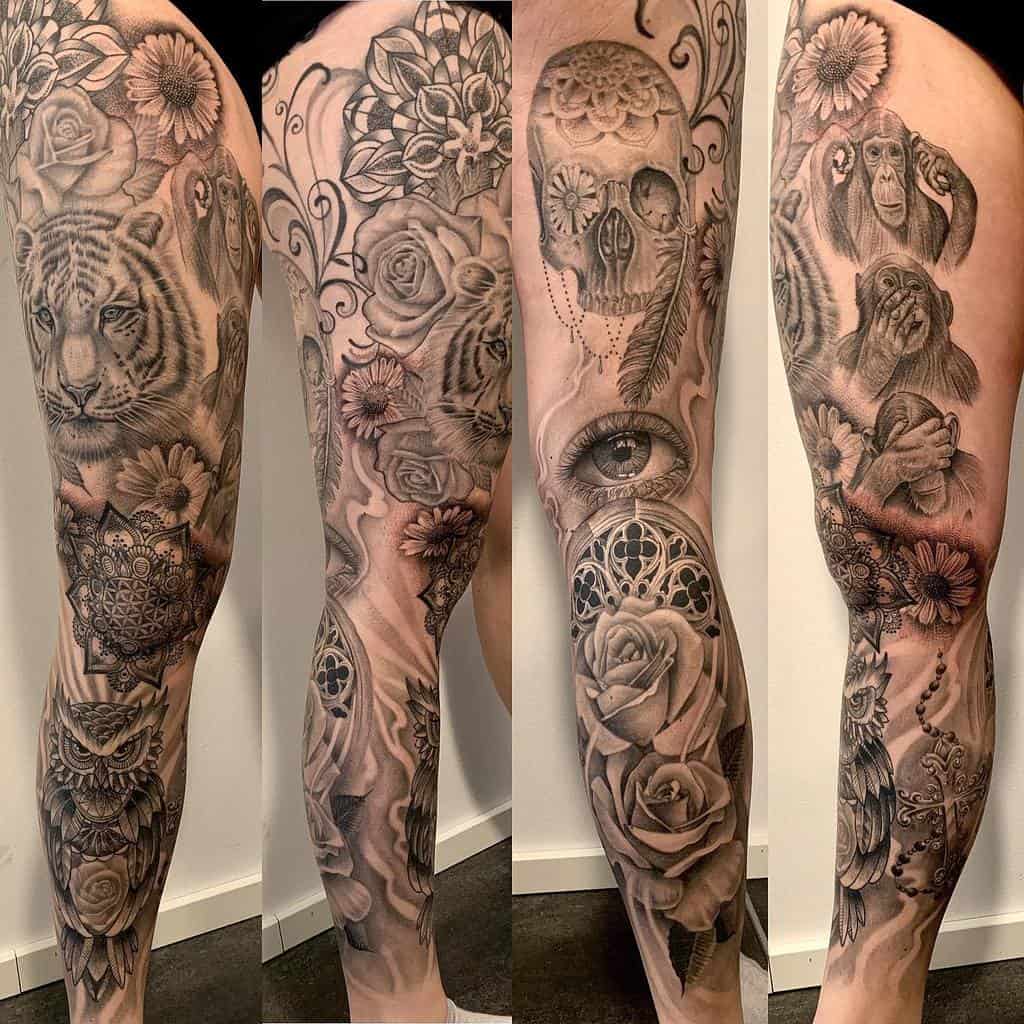 Detailed leg sleeve tattoo featuring a mix of animal imagery, including a tiger and monkeys, intricate floral patterns, a skull with a feather, and a symbolic eye, all combined with mandala design