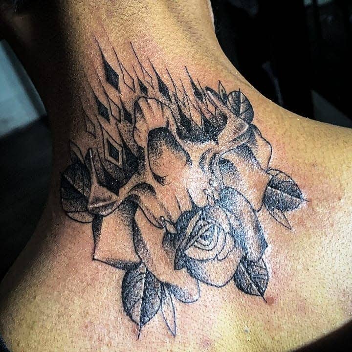 Black and grey neck tattoo of a skull merging into a rose, featuring sharp geometric elements and intricate shading.