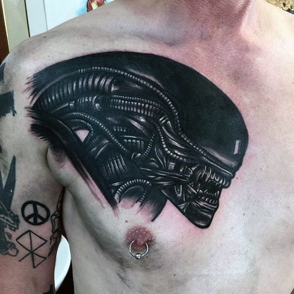 Black Ink Alien Tattoo On Guys Chest