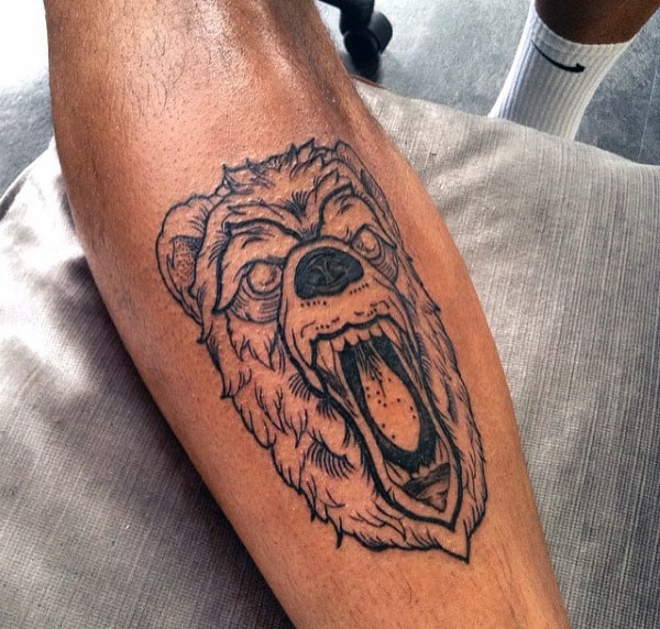 Black Ink Bear Face Shin Tattoo On Man