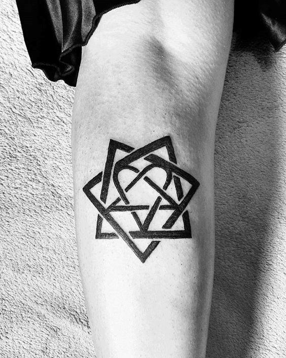 Geometric black tattoo, featuring overlapping triangles and lines in a star-like pattern with heart in the center