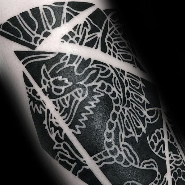 Black and white dragon tattoo featuring geometric patterns and bold lines