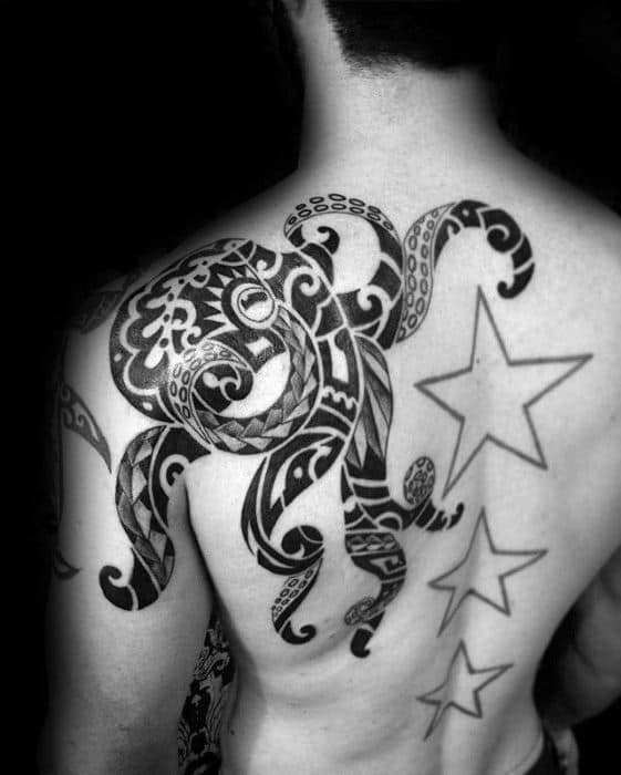 A tattoo of a large octopus with tribal design and three stars on the back