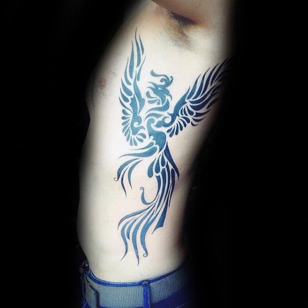 Black Ink Phoenix Tribal Tattoo On Gentlemans Rib Cage Side