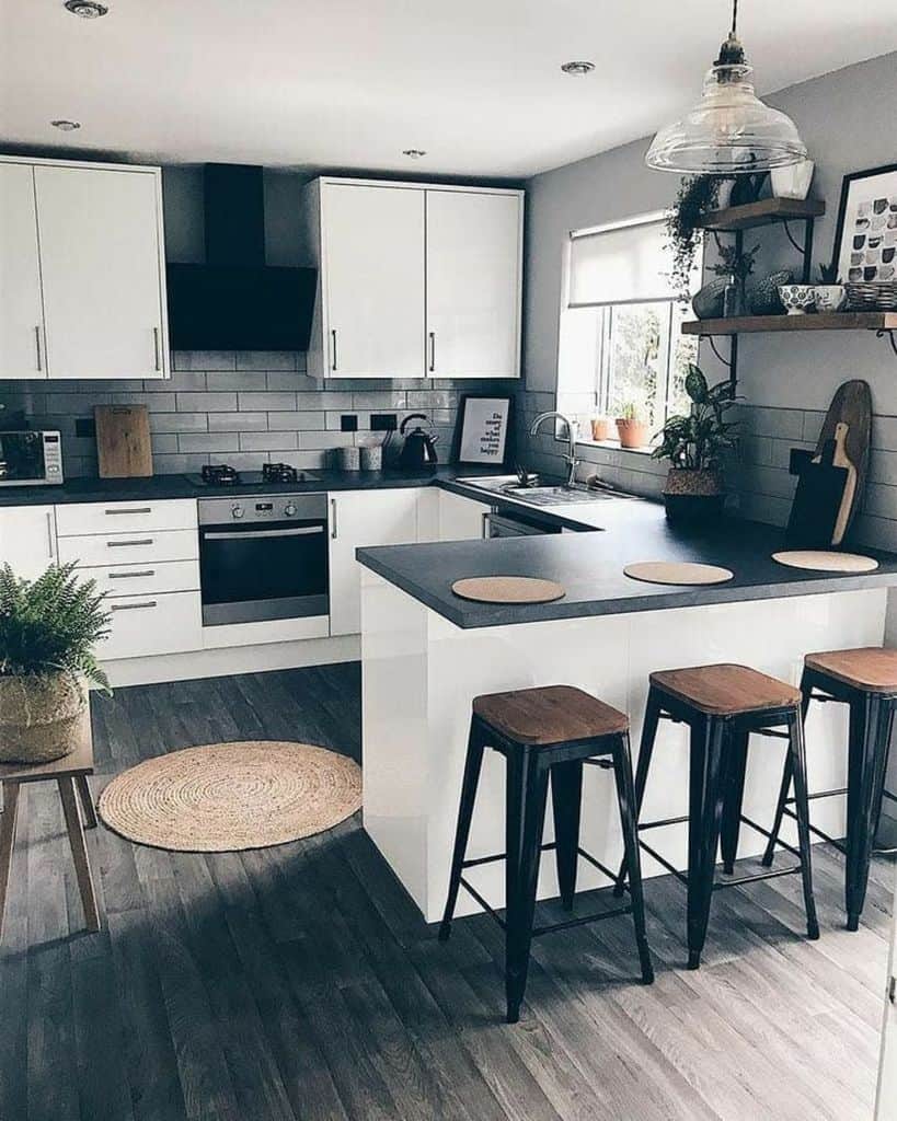 modern kitchen with white cabinets black countertop wood and metal stools