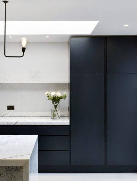 minimalist kitchen with black cabinets and white marble countertops 