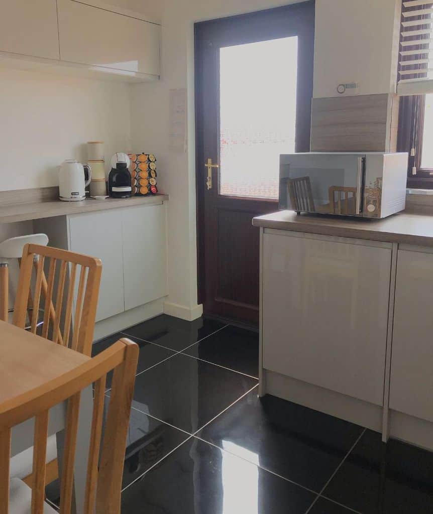large black floor tiles white kitchen
