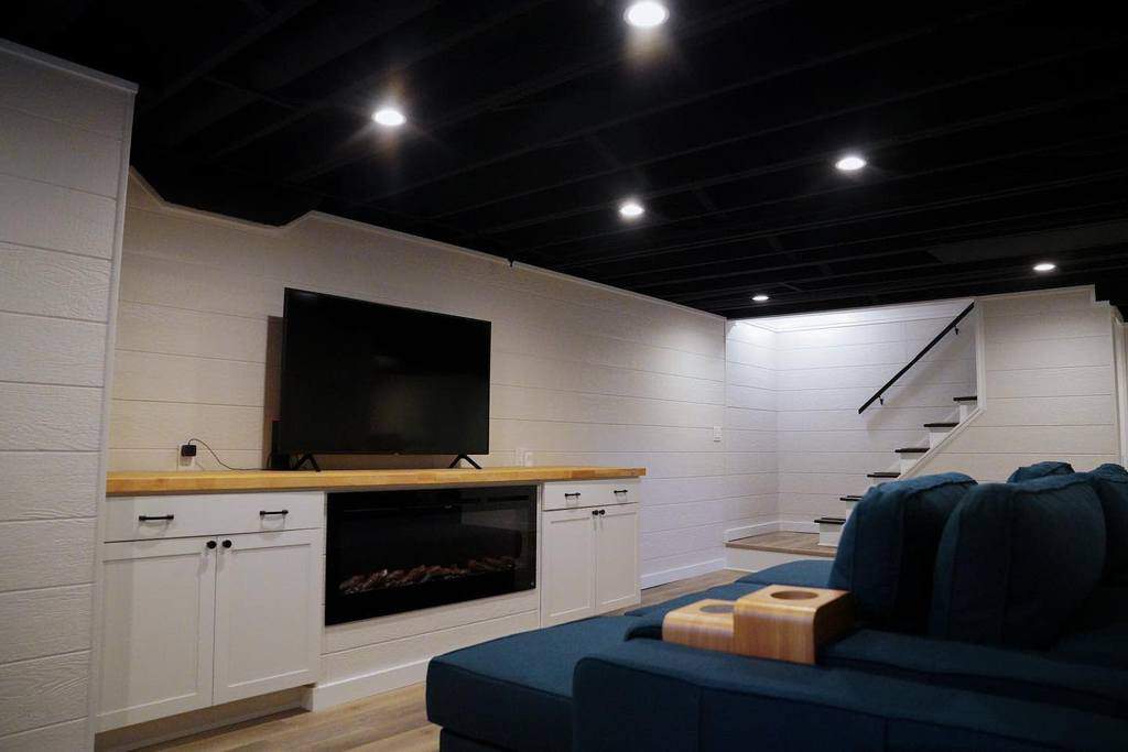 basement movie room with blue sofas