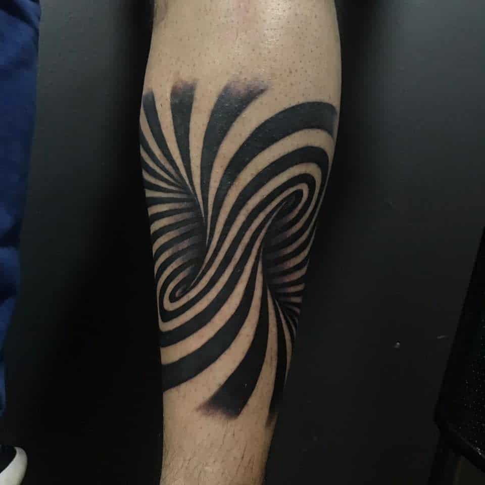 Leg tattoo with bold black optical illusion waves, creating a hypnotic and dynamic 3D effect for a striking modern design.