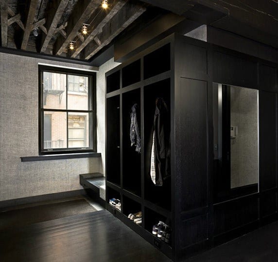 modern stylish black mudroom with cabinets and show storage