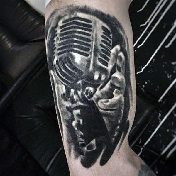 Black Pencil Shade Of Hand Holding Microphone Tattoo Guys Arms