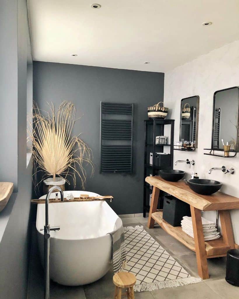 luxury modern bathroom with gray accent wall and white tub