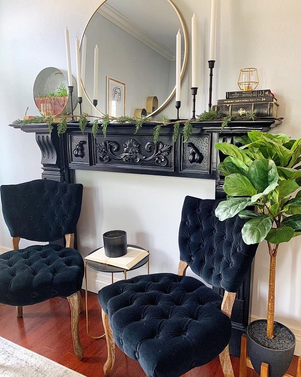 black white faux fireplace surround gold accent mirror candlesticks accent chairs