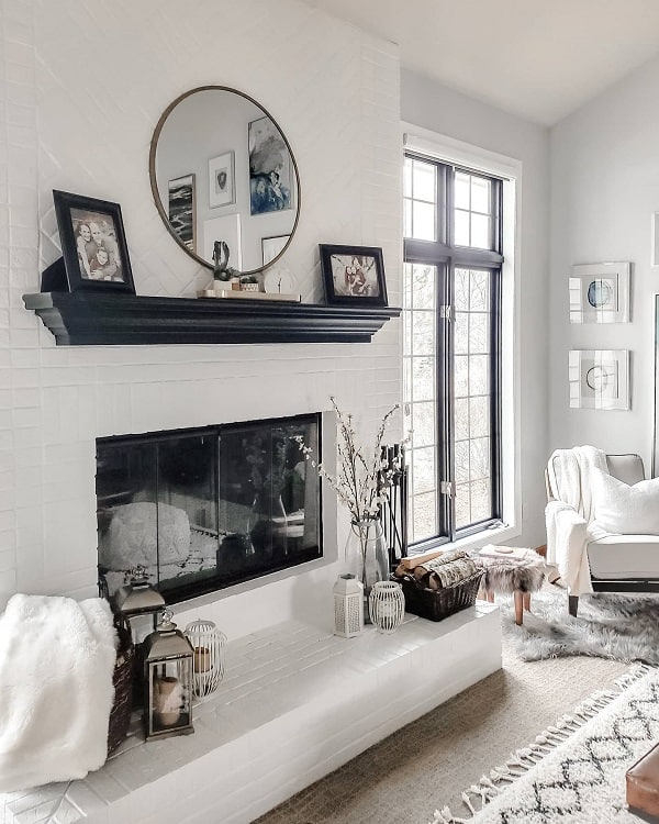 black white modern brick fireplace luxury living room wall mirror white accent chair