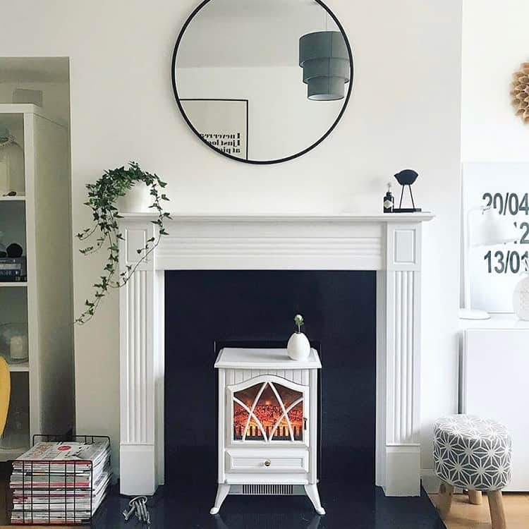black and white tile fireplace surround wall mirror small stool