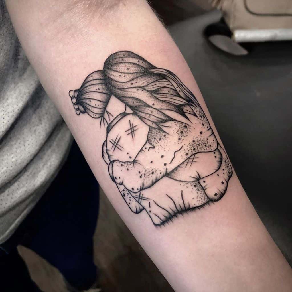 Black and grey tattoo depicting two sisters hugging, with detailed linework and shading emphasizing their bond and closeness
