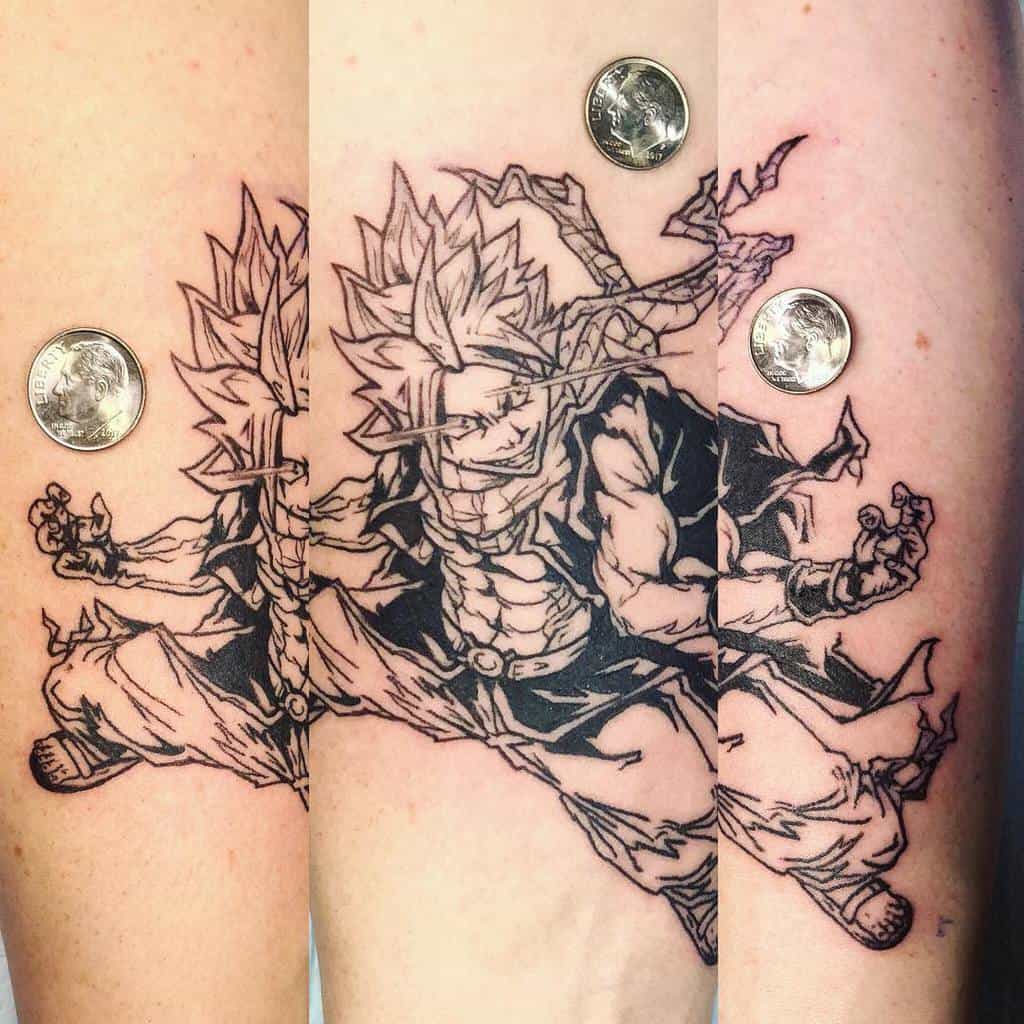 Dynamic black ink tattoo of Natsu Dragneel from Fairy Tail in an action pose, with intricate linework and bold shading on the forearm.