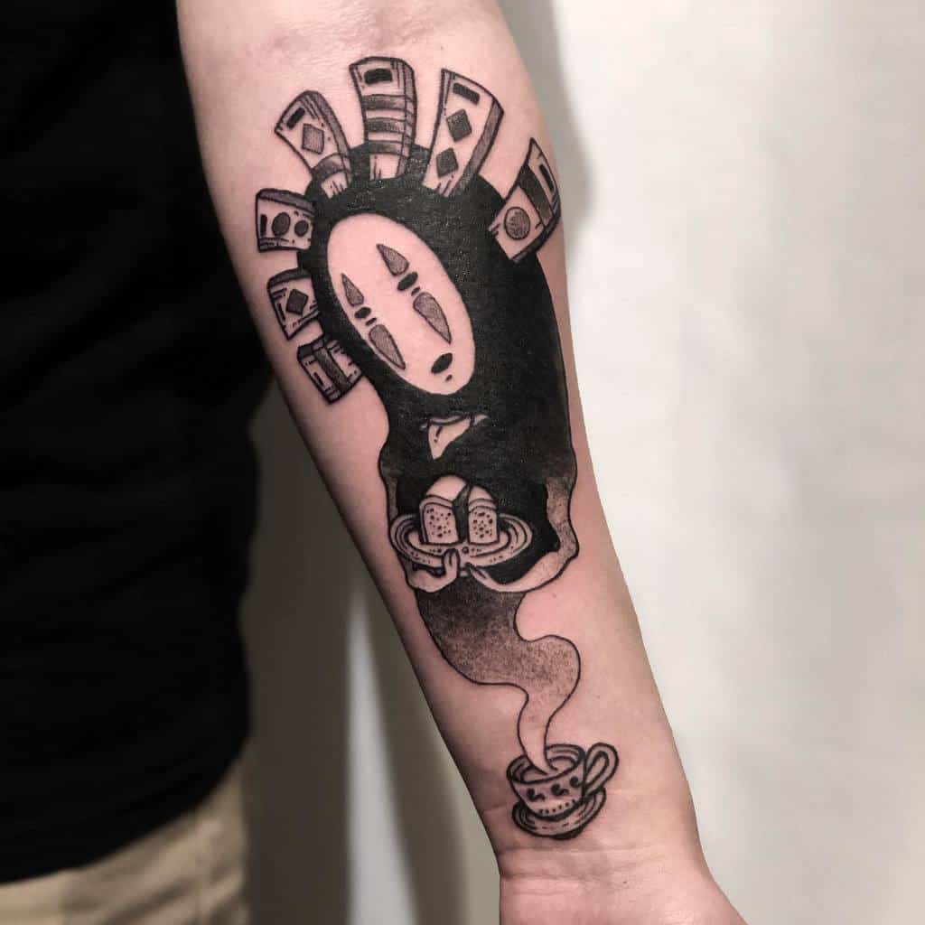 Black ink tattoo of No-Face from Spirited Away, holding two breads in a plate, transforming into steam from a teacup