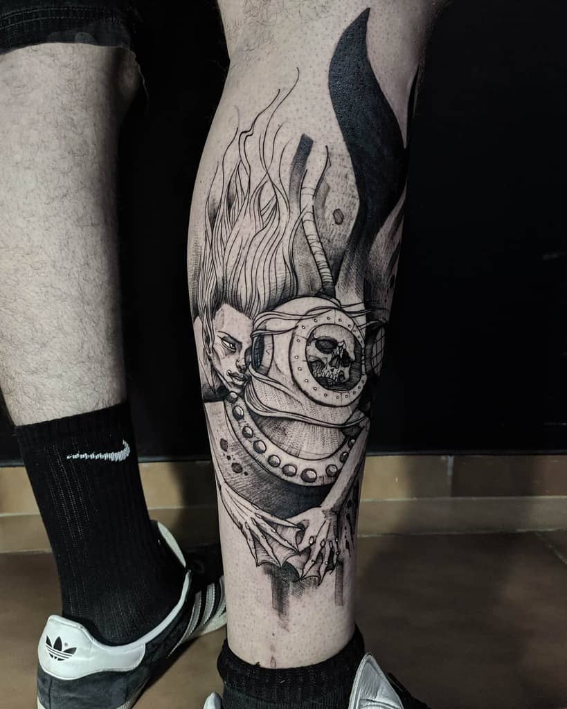 Dark black and grey tattoo of a haunting mermaid gripping a deep-sea diver’s helmet, revealing a skull inside, with flowing hair and eerie details.