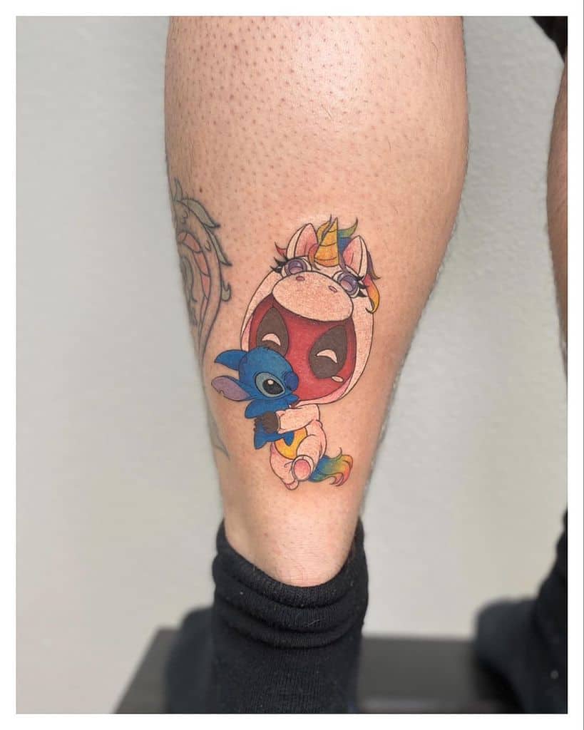 Colorful tattoo of Stitch from Lilo & Stitch inside a unicorn costume, on the lower leg, with a playful and vibrant design.