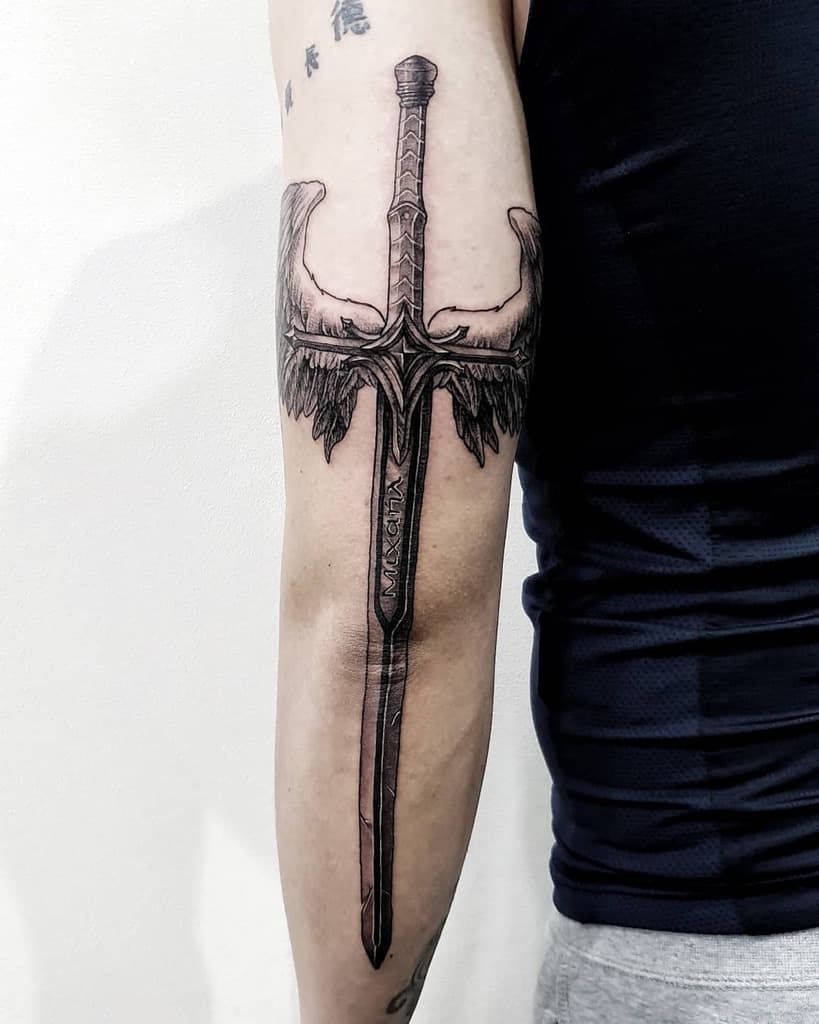 Intricate sword tattoo with angel wings symbolizing strength, protection, and divine guidance in a bold design.