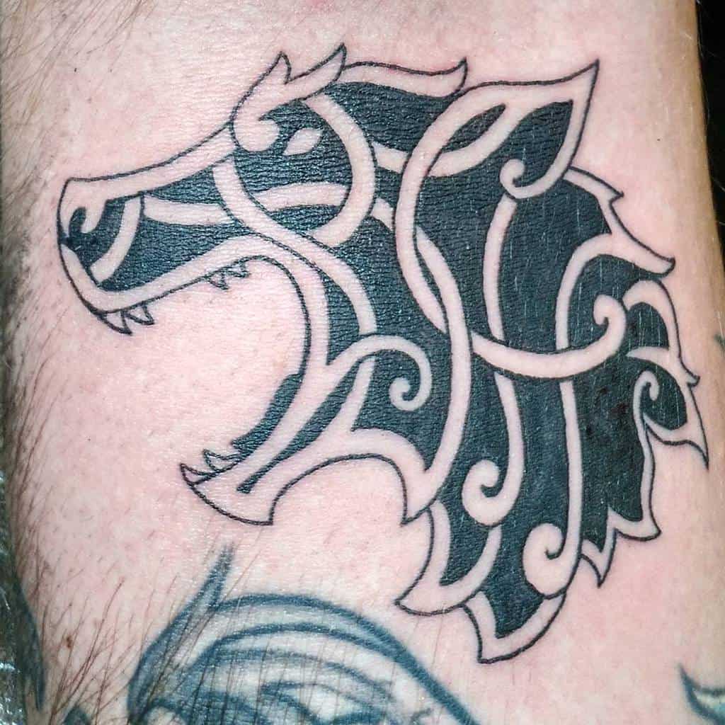 Minimalistic blackwork Norse wolf tattoo in a knotwork-inspired design, emphasizing clean lines and bold contrast