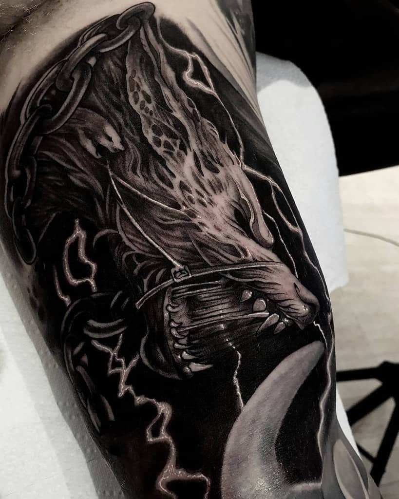 Intricately detailed black and grey Norse wolf tattoo with lightning elements, chains, and a crescent moon for a powerful and dramatic composition