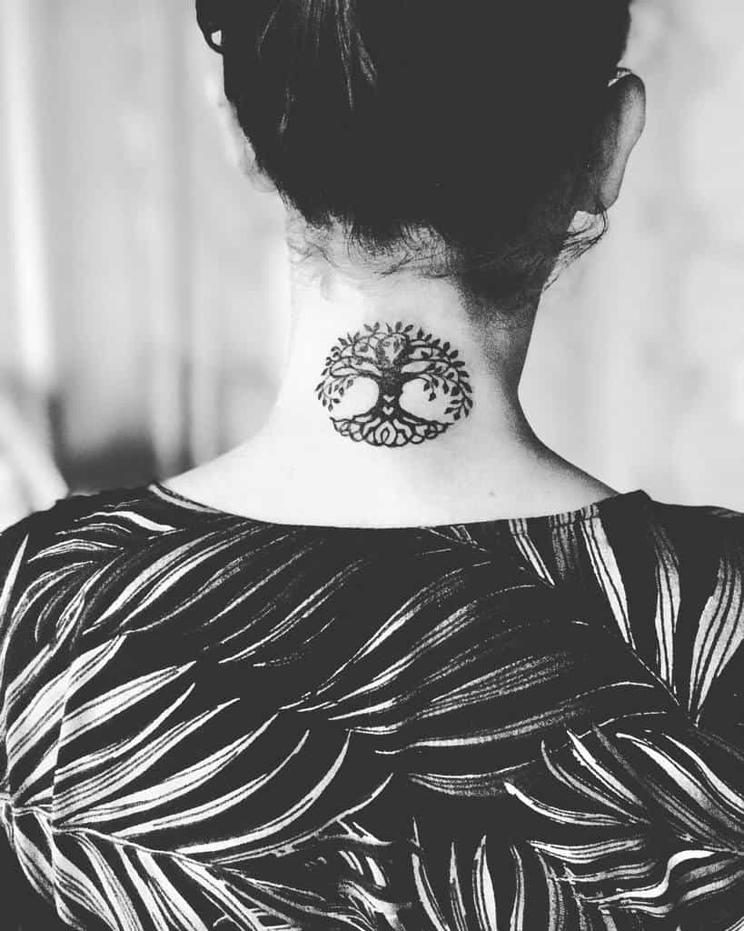 Minimalistic blackwork tree of life tattoo located at the nape of the neck, blending simplicity with symbolic depth