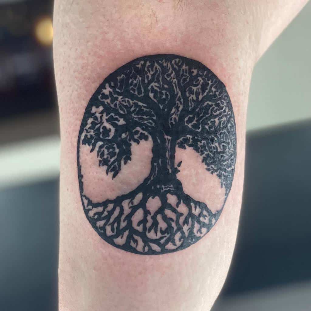 Minimalist blackwork tattoo of the tree of life, symbolizing growth, resilience, and balance, enclosed within a circular design