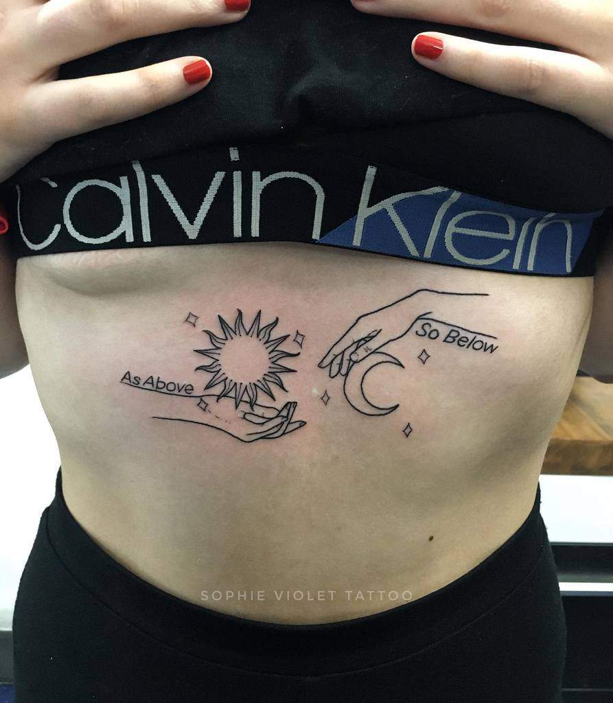 Elegant blackwork tattoo featuring the text 'As Above, So Below' with minimalist hands holding celestial symbols of the sun and moon, representing harmony between the cosmic and earthly realms