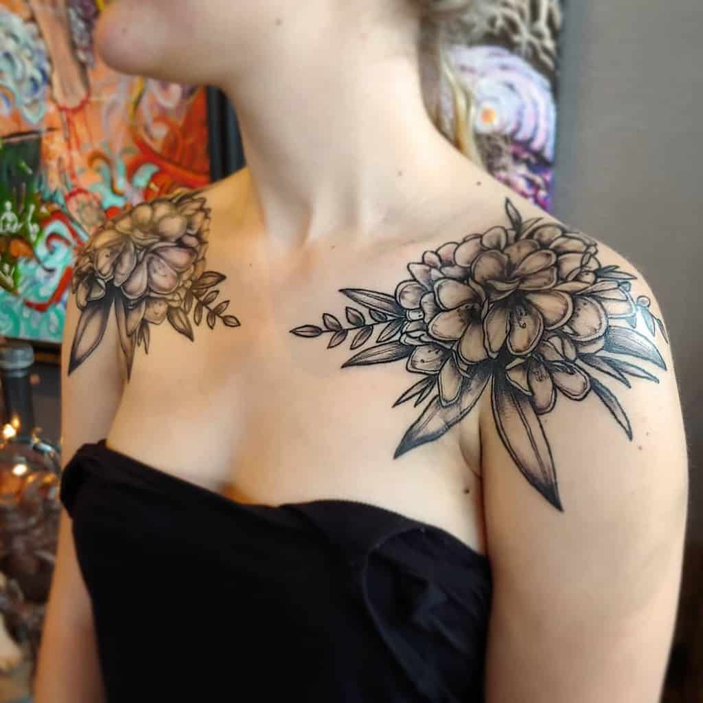 Woman with detailed floral tattoos on shoulders
