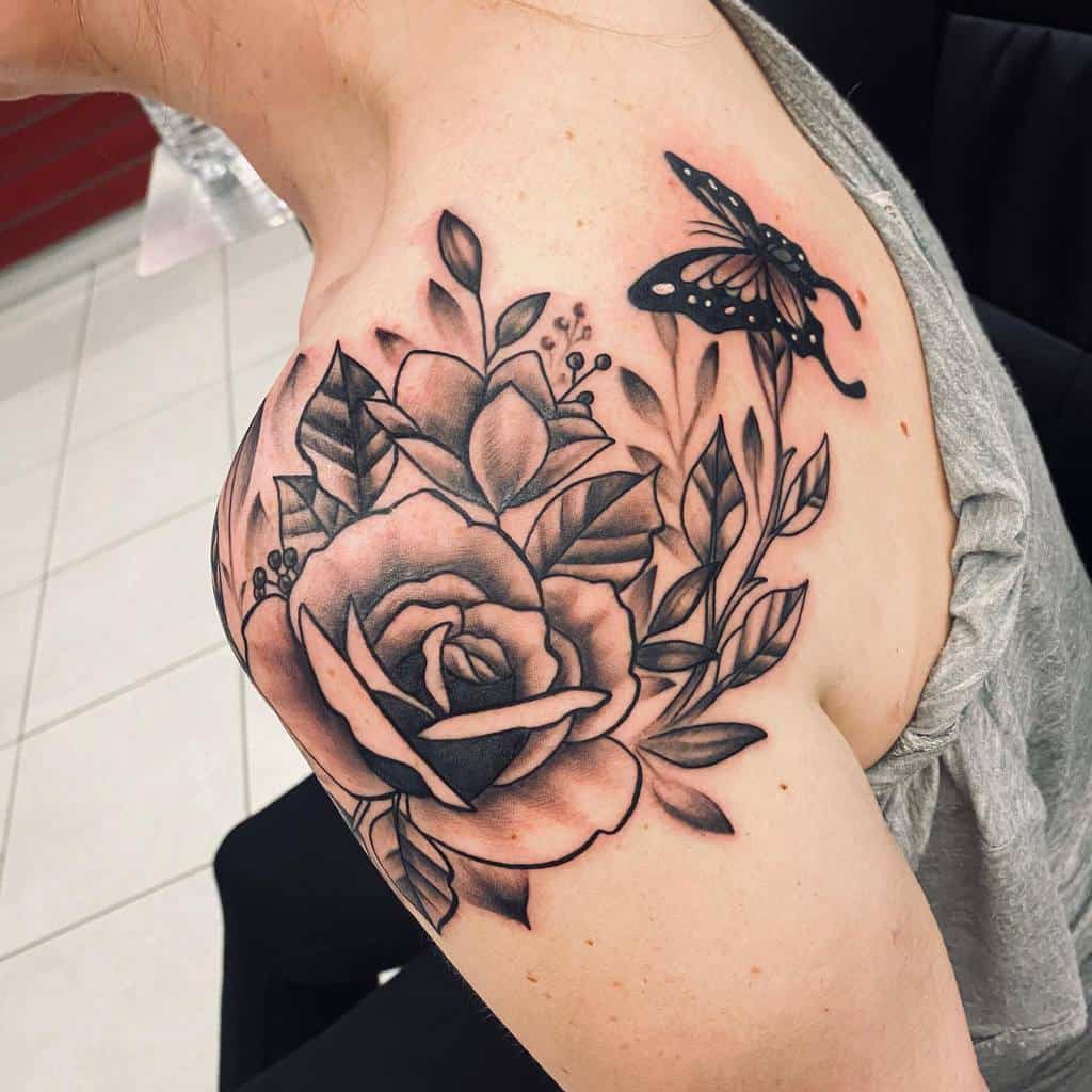 A black rose and butterfly tattoo graces the shoulder and upper arm