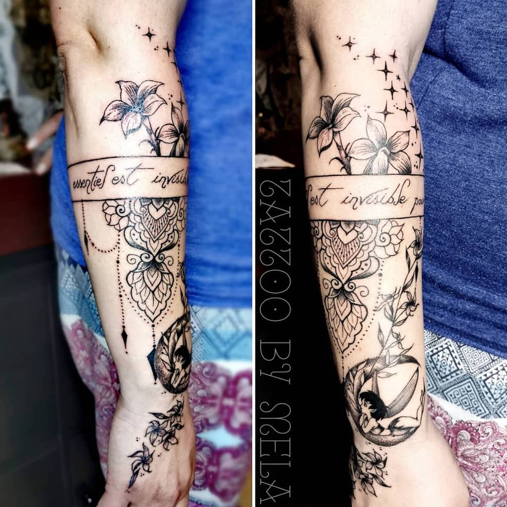 Forearm tattoo featuring Jasmine flowers, mandalas, and an inscription in French