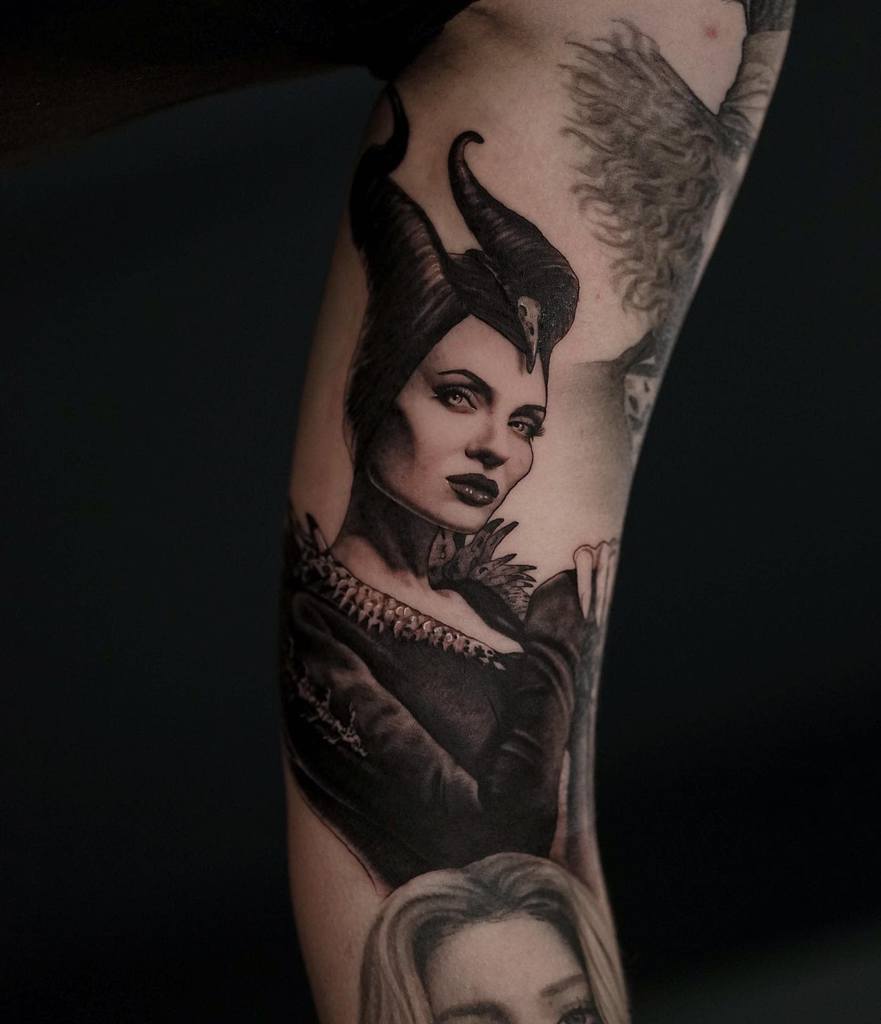 Intricate blackwork tattoo of Maleficent with stunning realism, showcasing her piercing gaze, iconic horns, and dark elegance